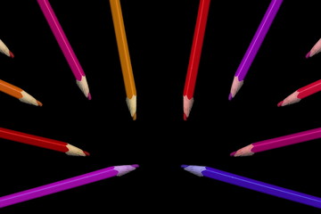 Old colored pencils lying on a black background - 279034542