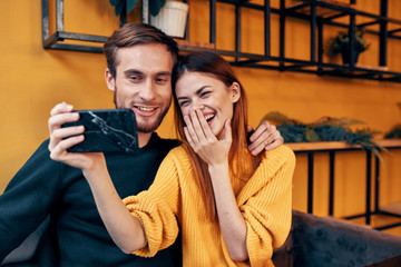 young man and woman talking on cell phone