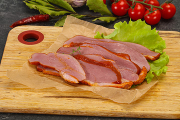 Sliced smoked duck breast served salad