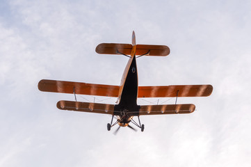 View on an old plane flying during the sunset
