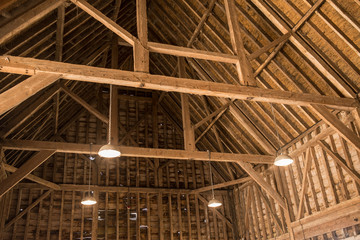Inside view of old wooden roof wood structure with wooden beams in old barn - 279035736