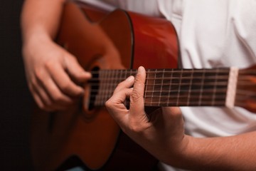 Fototapeta na wymiar Man playing an acoustic guitar