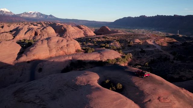 Moab Utah 4x4 Offroad Slickrock Trail Driving as Moon Rises at Sunset