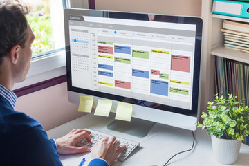 Calendar software showing busy schedule of manager with many meetings, tasks and appointments...
