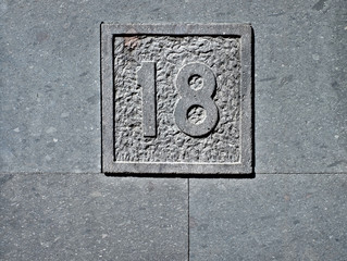Eighteen / 18, to come of age, number plate in stone.