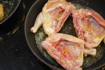 Process of cooking and roasting meat in a pan. 