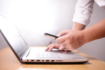 Businessman Using Smart Phone and Laptop