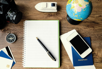 Notepad, credit cards, passport, ticket, camera, phone and compass.