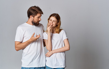 Fototapeta premium Young couple in white t-shirts chatting