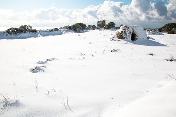 Uluzzo tower after a exceptional snowfall, Salento, Italy