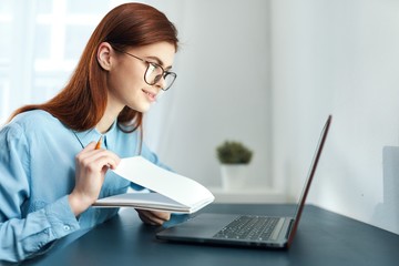 young woman working on laptop in office