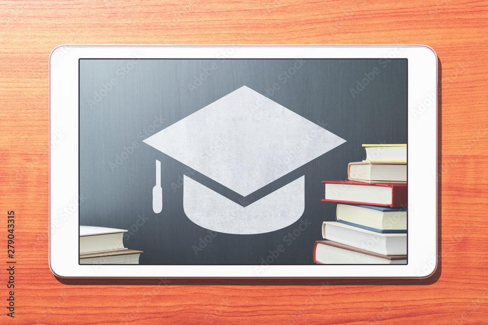 Poster e-learning concept image. tablet computer on wooden desk. book, bachelor's cap icon and blackboard. 