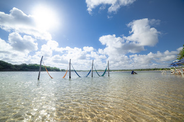 Fototapeta premium Tranquil water resting nets and bright sun. Natal, Rio Grande do Norte, Brazil.