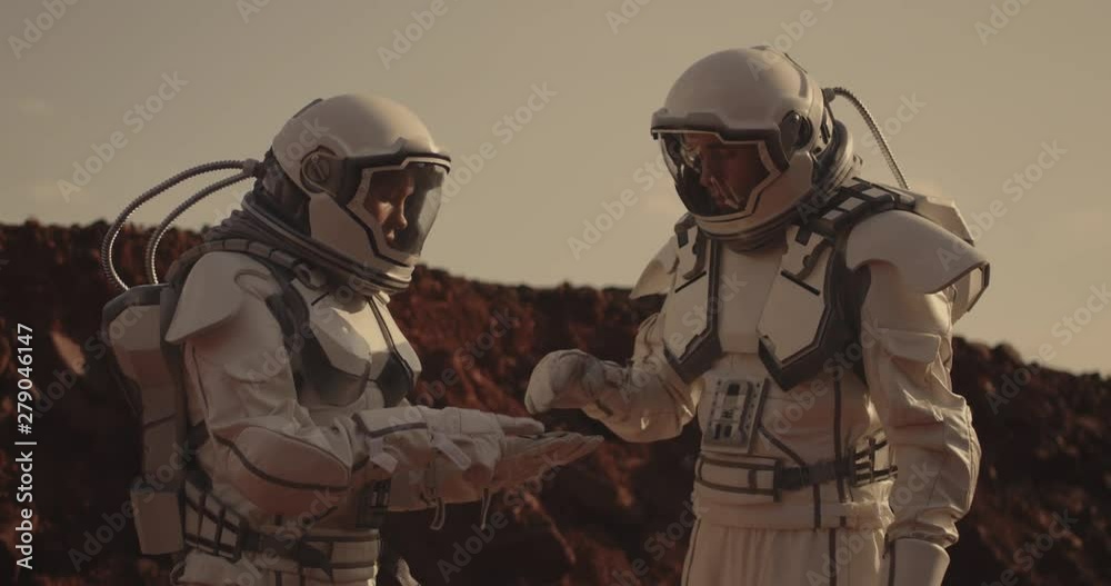 Wall mural two astronauts examining sample on mars
