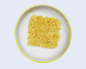 Instant noodles are in a white plate. Isolated on white background