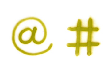 Graffiti email and hashtag sign sprayed on white isolated background