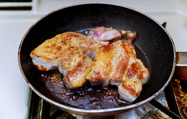 Pork chops in a skillet, ready to eat