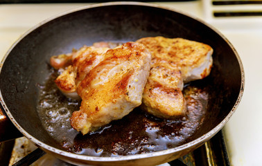 Fried chopsteak meat in a frying pan, close up