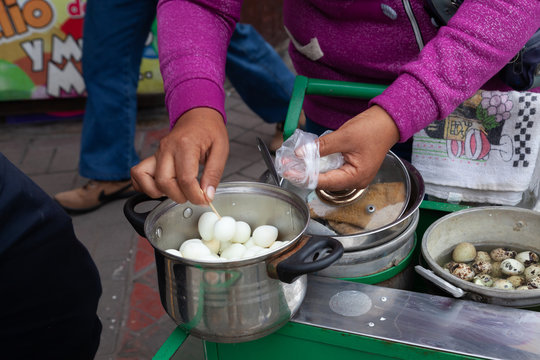 hands serving quail eggs