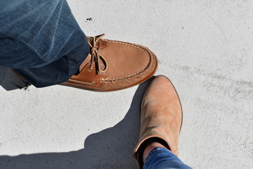 Two brown shoes on a gray background