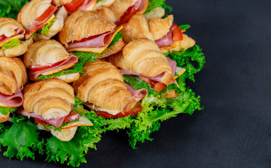 Croissants with ham, cheese and tomato on plate