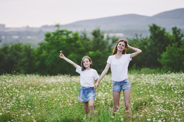 Fototapeta premium mother and daughter having fun in the field