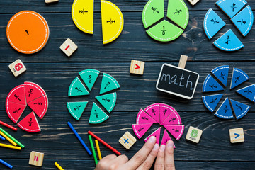 Creative Сolorful math fractions on dark background. Interesting funny math for kids. Education,...