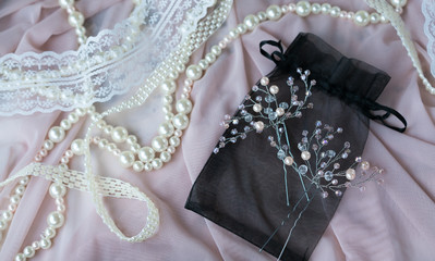 Wedding background with pearls and hair accessories on pink background