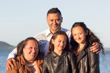 Portrait of a young Maori family taken outdoors