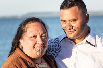 Portrait of an attractive Maori couple taken outdoors - obrazy, fototapety, plakaty
