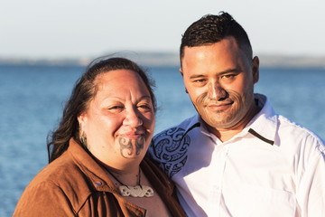 Portrait of an attractive Maori couple taken outdoors - obrazy, fototapety, plakaty