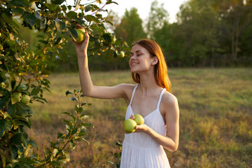 young woman with green apple in the park