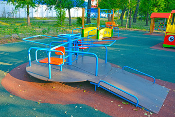 Children's revolving carousel in the park, for children with disabilities.