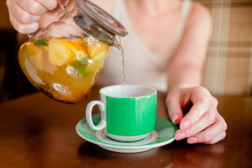 Female hands hold hot green  coffee cup beverage, drinks cappuccino. Horizontal several objects copyspace