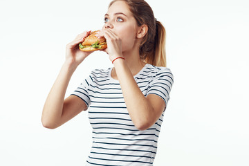 young woman eating salad isolated on white