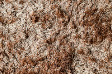Brown fabric carpet with long pile texture