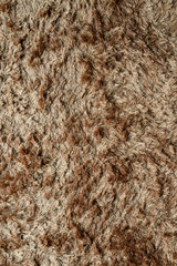 Brown fabric carpet with long pile texture