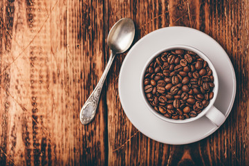 Cup full of roasted coffee beans
