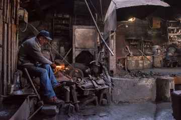 the blacksmith polishing metal products