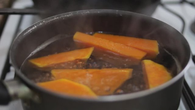closeup pot cooking squash in boiling water