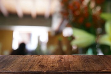 Empty dark wooden table in front of abstract blurred bokeh background of restaurant . can be used for display or montage your products.Mock up for space.