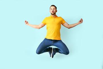 Funny jumping man on color background