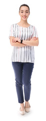 Fototapeta premium Smiling young business woman standing with arms crossed isolated on white background, full length portrait of confident female professional in casual office wear