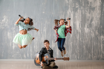 Band of little musicians against grunge wall
