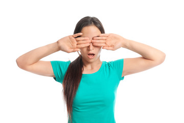 Young woman covering her eyes on white background