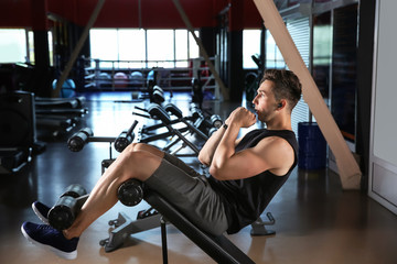 Fototapeta na wymiar Sporty young man training in gym