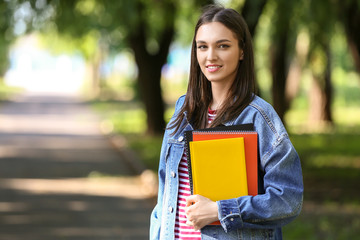 Beautiful female student in park