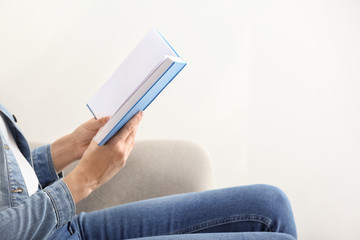 Woman reading book at home