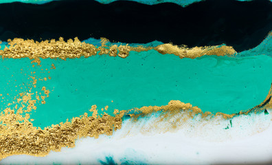 Fototapeta na wymiar Green and gold glitter pattern. Golden powder liquid texture.