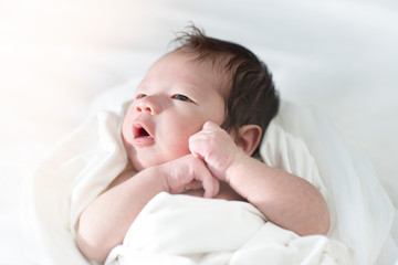 Fototapeta na wymiar Beautiful newborn baby lying in his bed